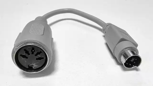 A photo of a passive 180° DIN to 6-pin Mini-DIN adapter